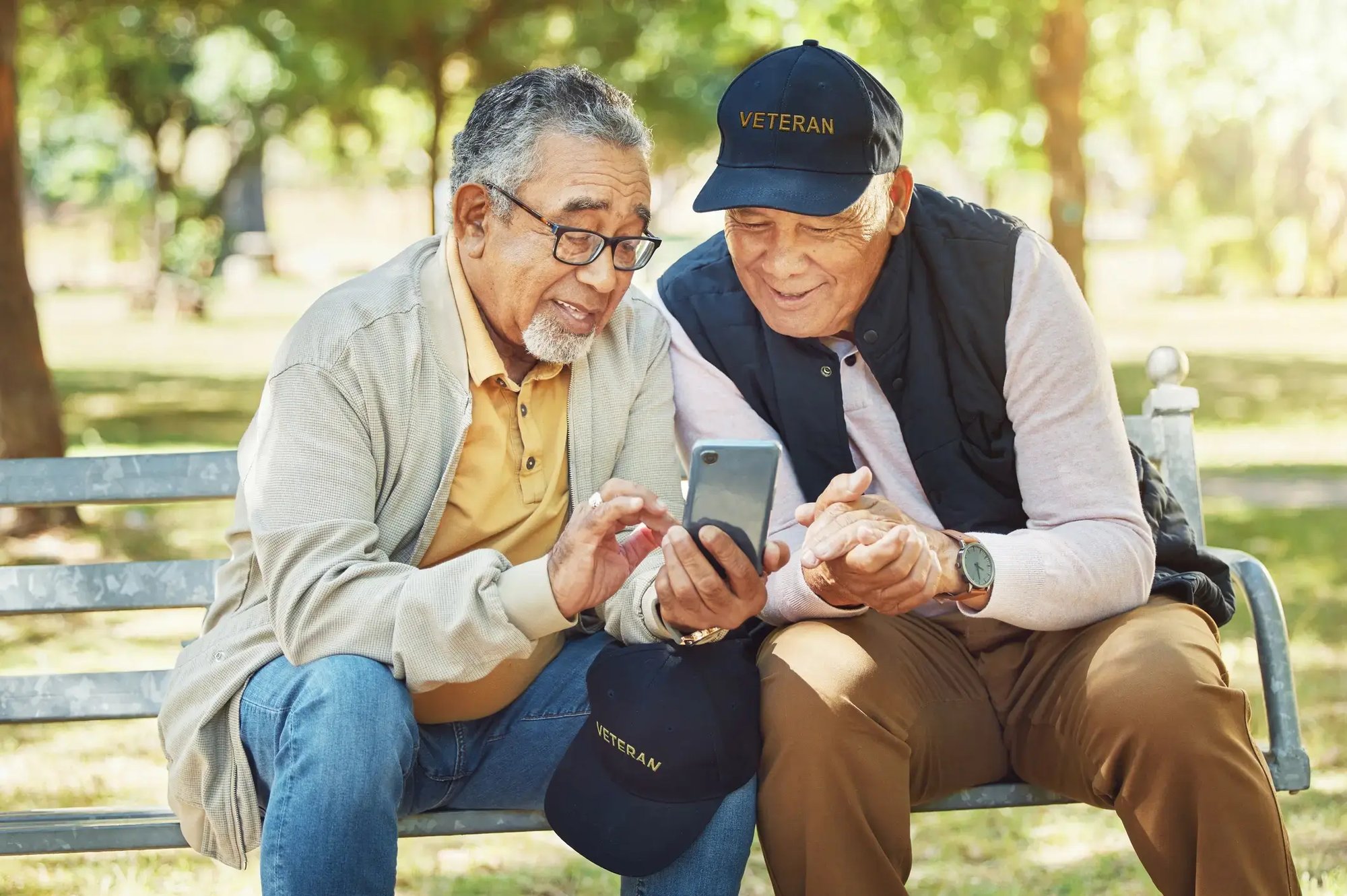 Two veterans looking at phone